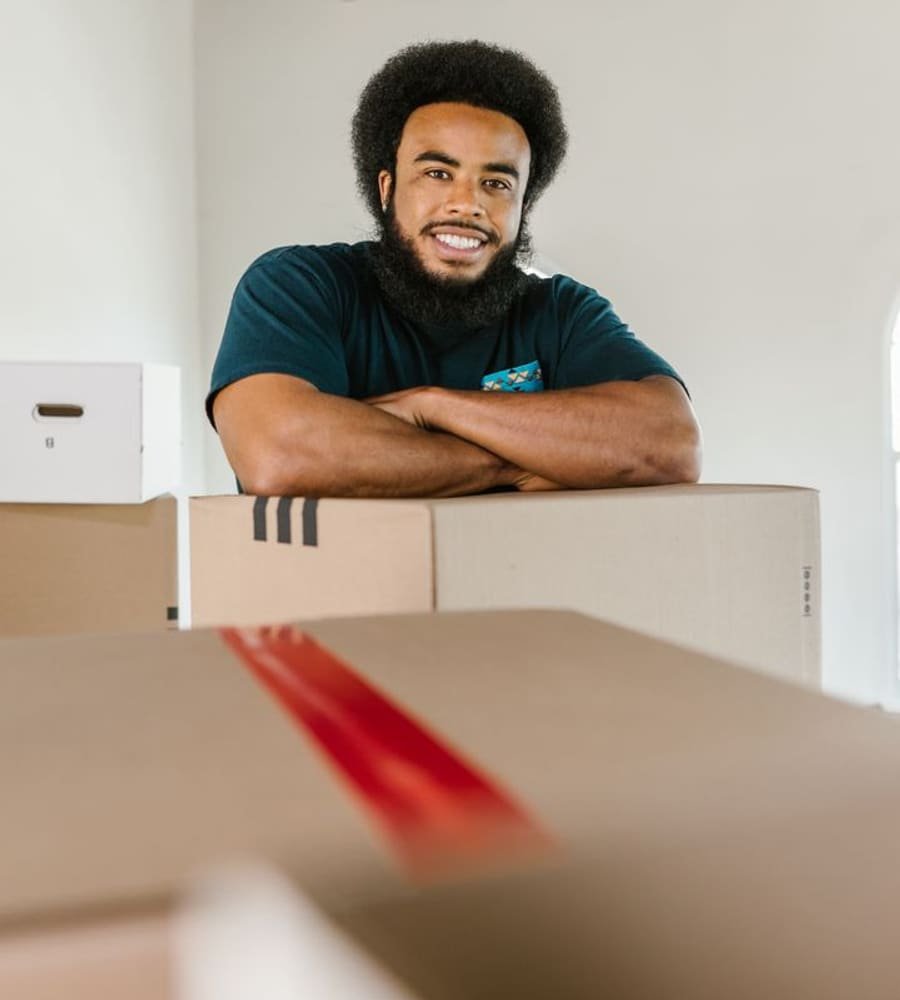 Friendly professional mover with packed boxes