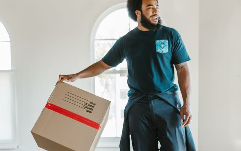 Movers carrying boxes during house shifting in Dubai